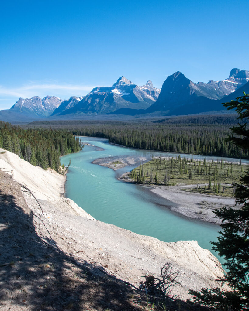 Goats and Glaciers lookout which has icy blue water and mountains behind it