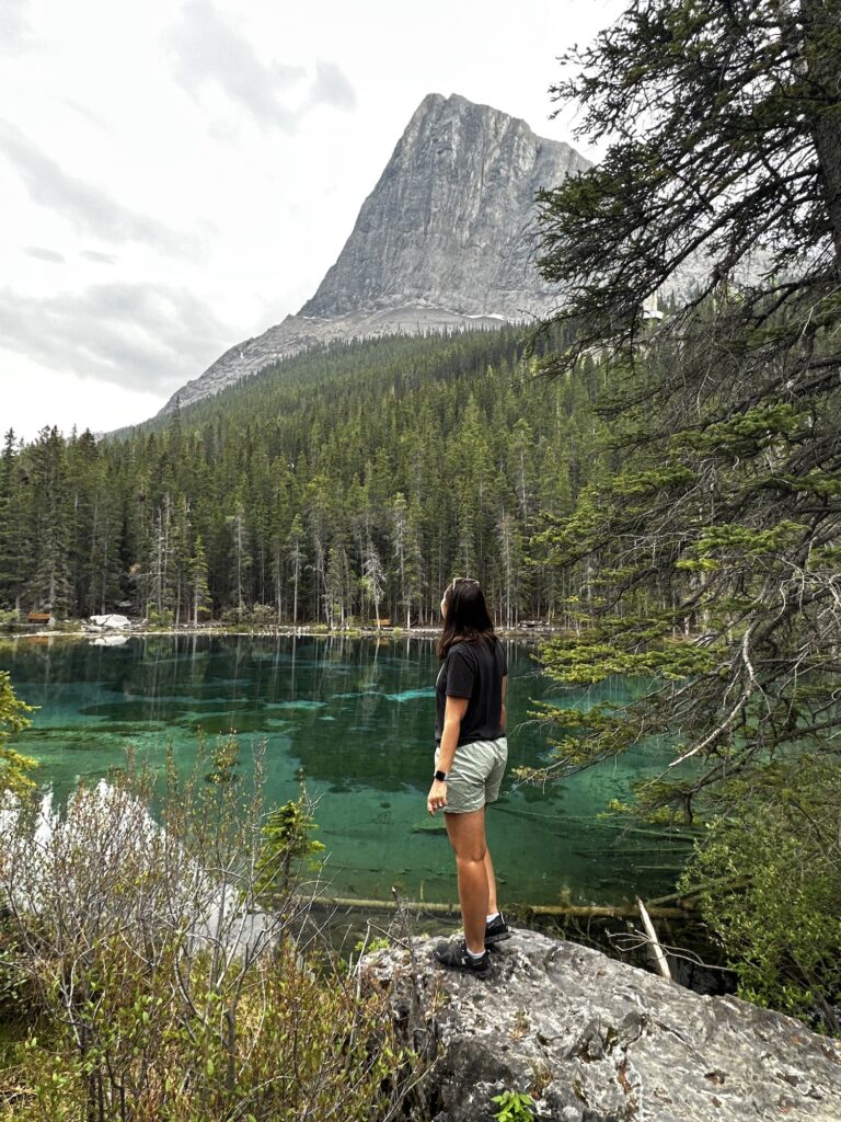 girl standing in front of turquoise Grassi Lakes and mountain