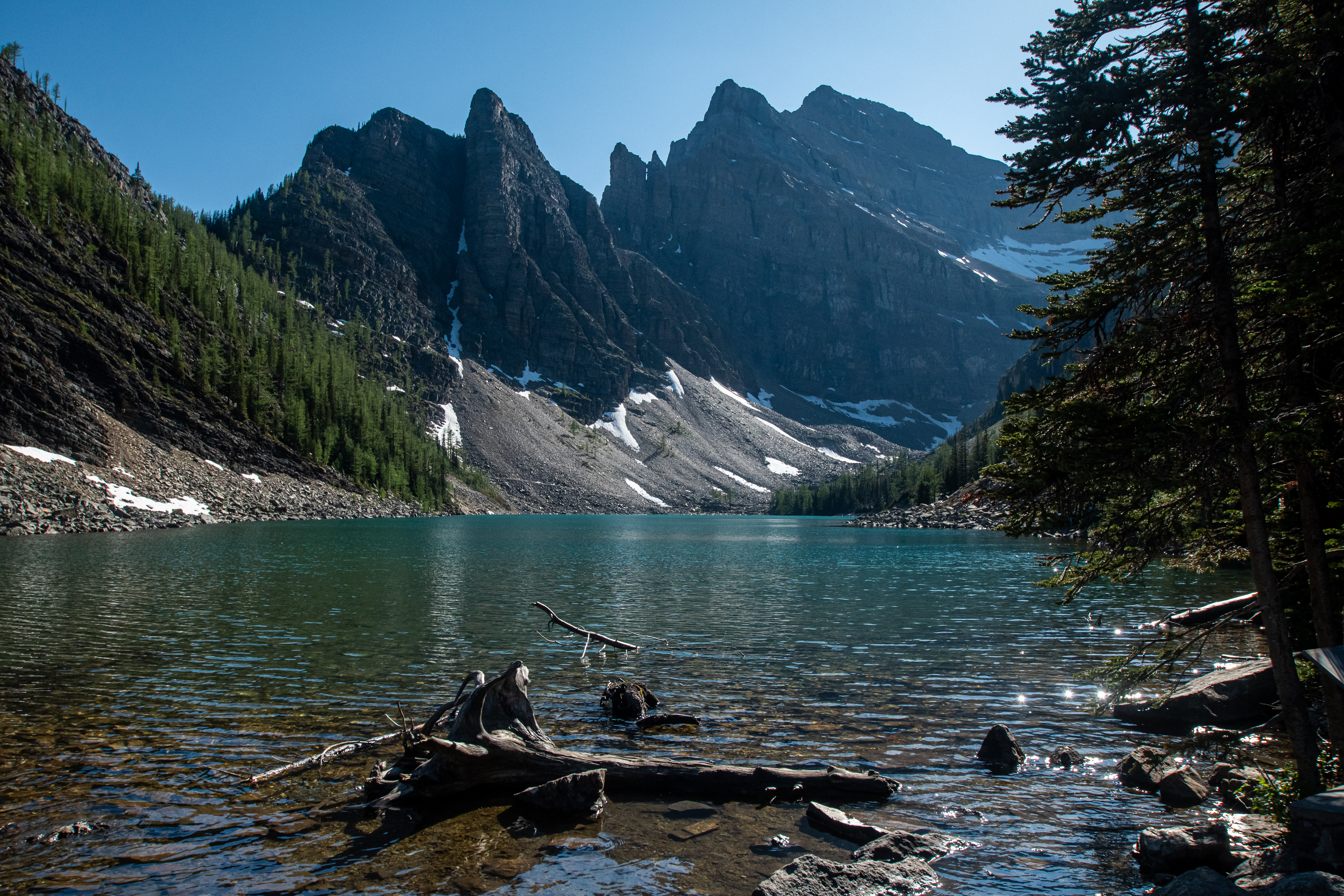 Lake Agnes with blue waters as mountains sit above