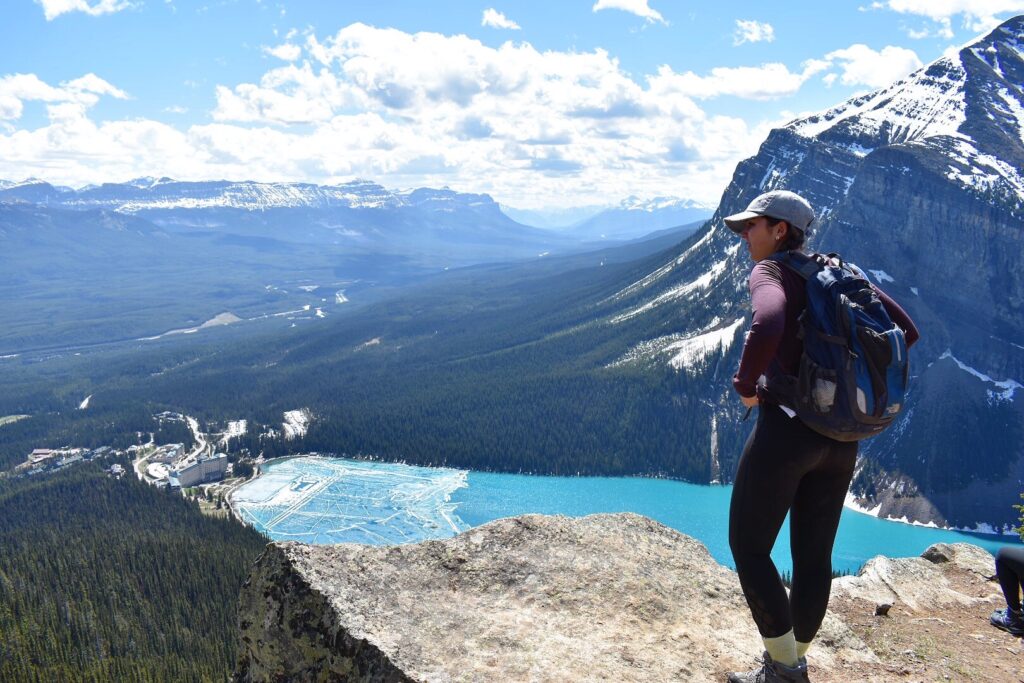 girl on top of a mountain overlooking Lake Louise