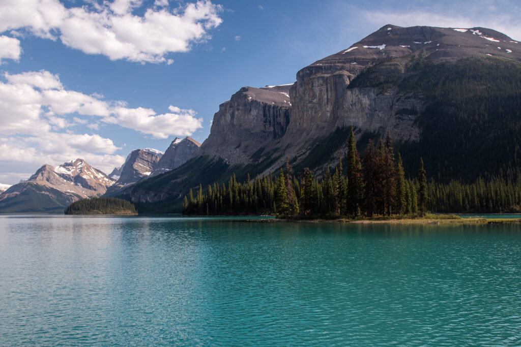 bright blue lake with mountains behind