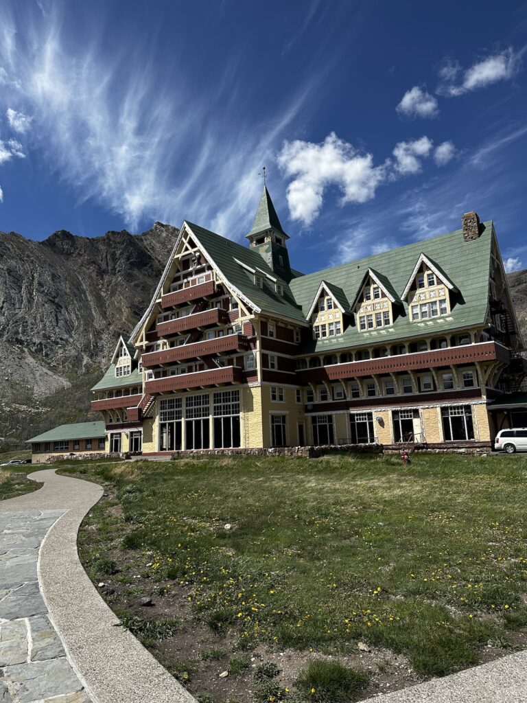 Prince of Wales Hotel with sunny skies and mountains behind