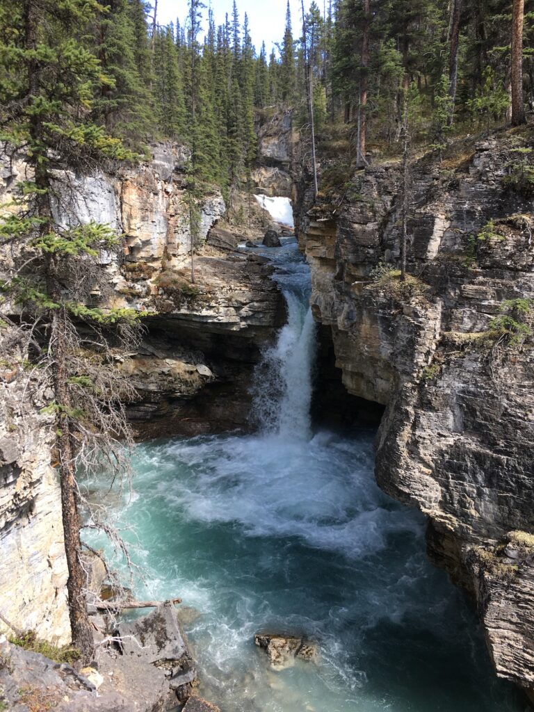 Falls in a pool of water in a canyon