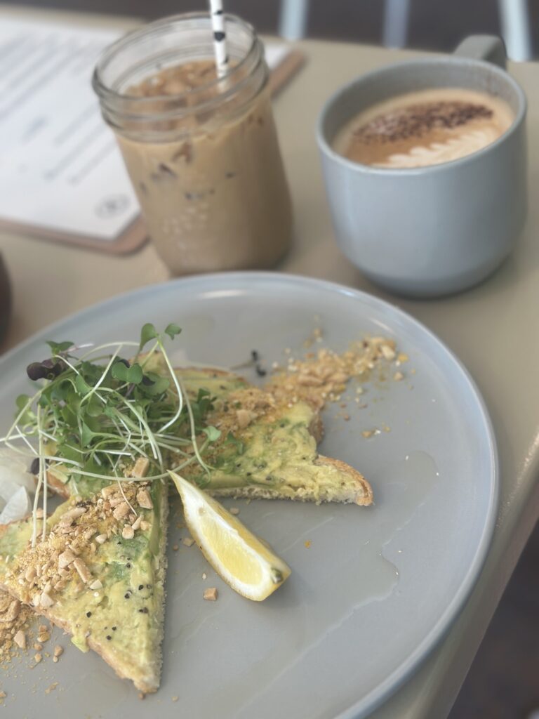 coffee and avocado toast on a table