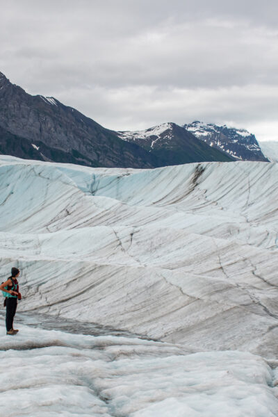 girl standing on root glacier trail