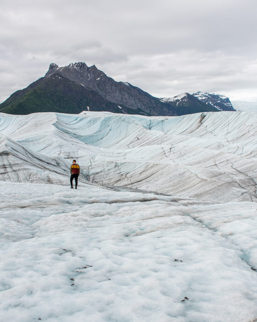 boy standing wtih root glacier behind him