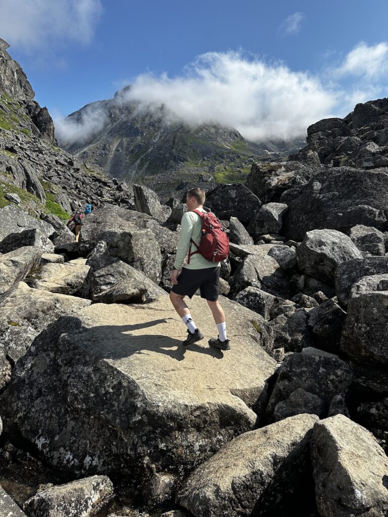 boy climbing up boulders of reed lakes trail