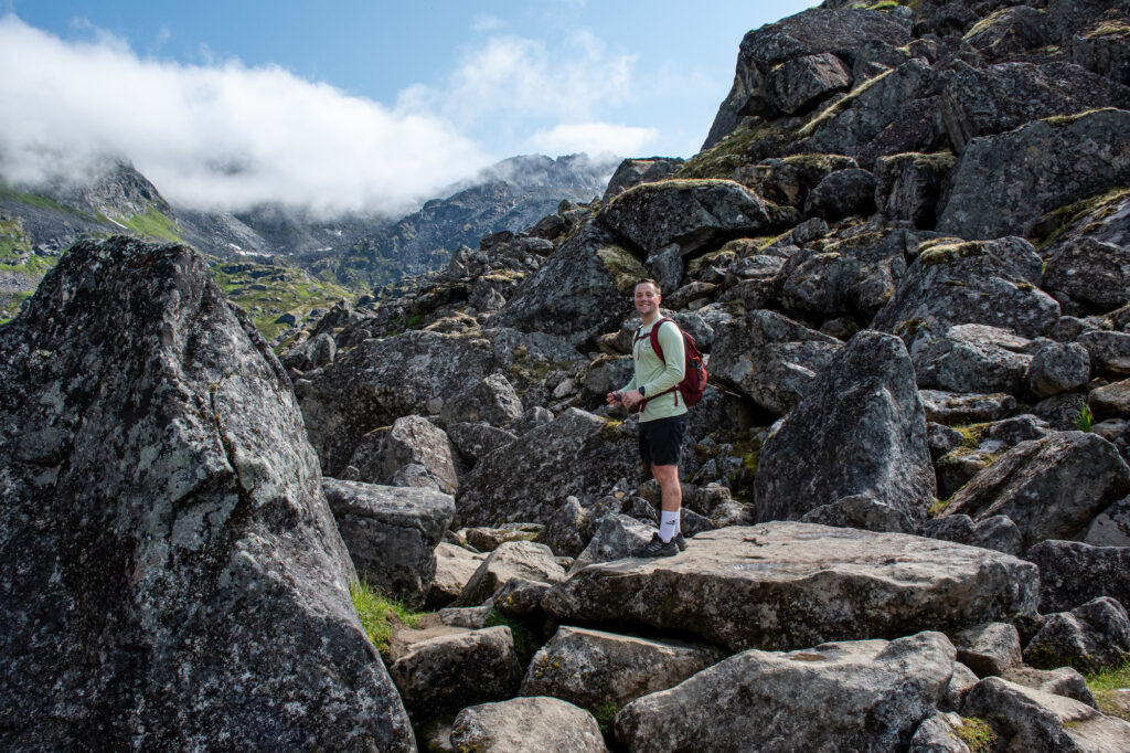 Dylan Smiling at the camera on the boulders