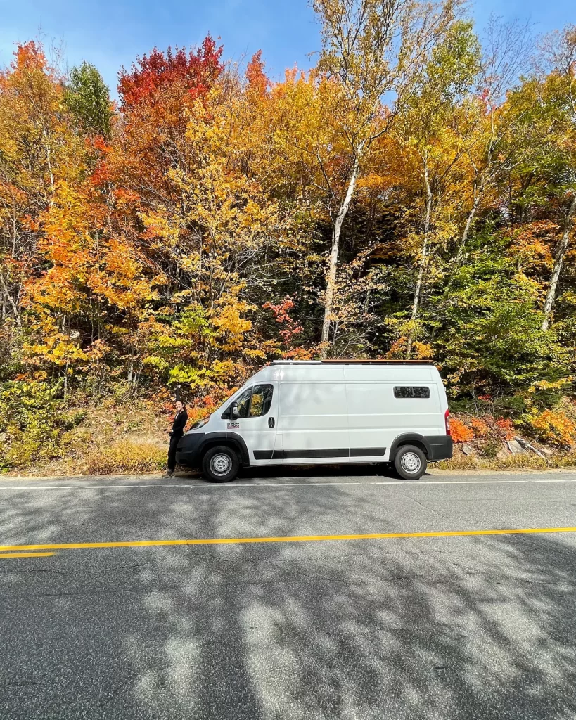 Van in front of vibrant trees