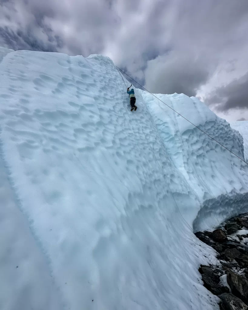 girl climbing up the top of the glacier