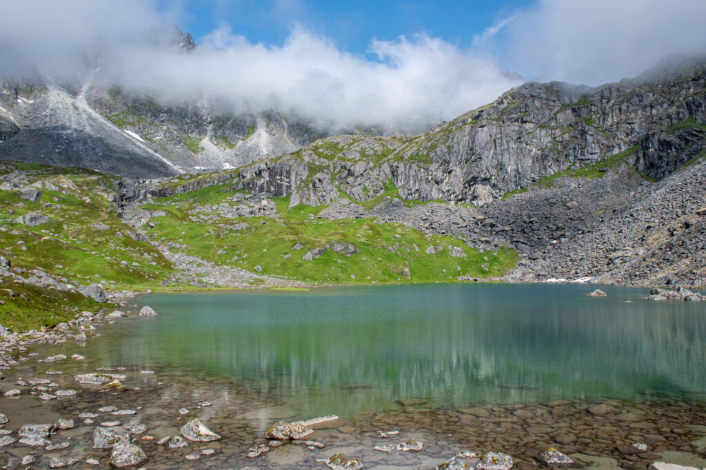turquoise water of a lake with mountain above