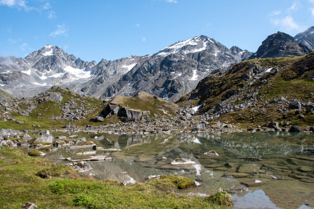 picture of mountains with a river in front ofit and rocks