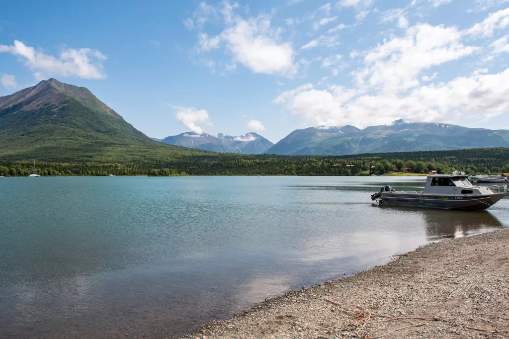 Tanalian Mountain sitting above Lake Clark with boats in the water