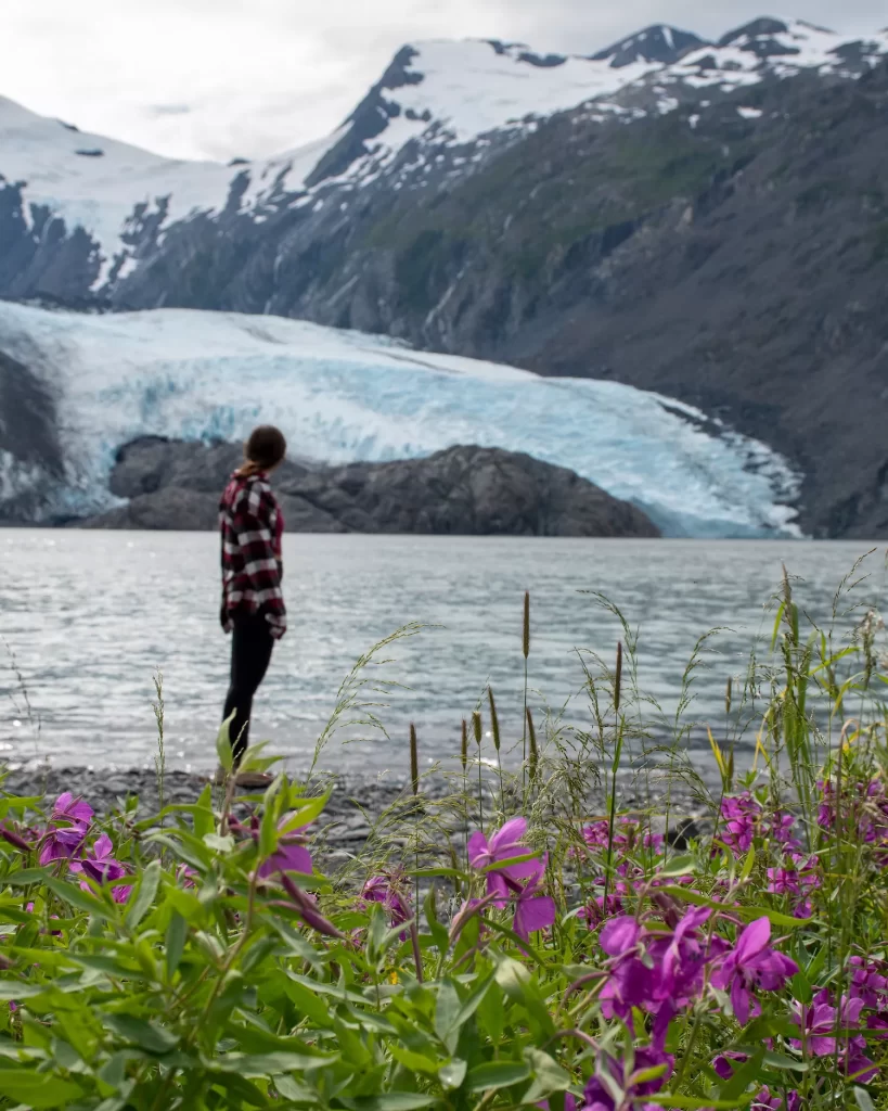 girl standing in front of portage glacier