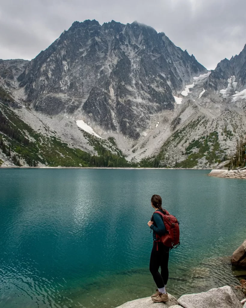 girl staring at a turquoise lake
