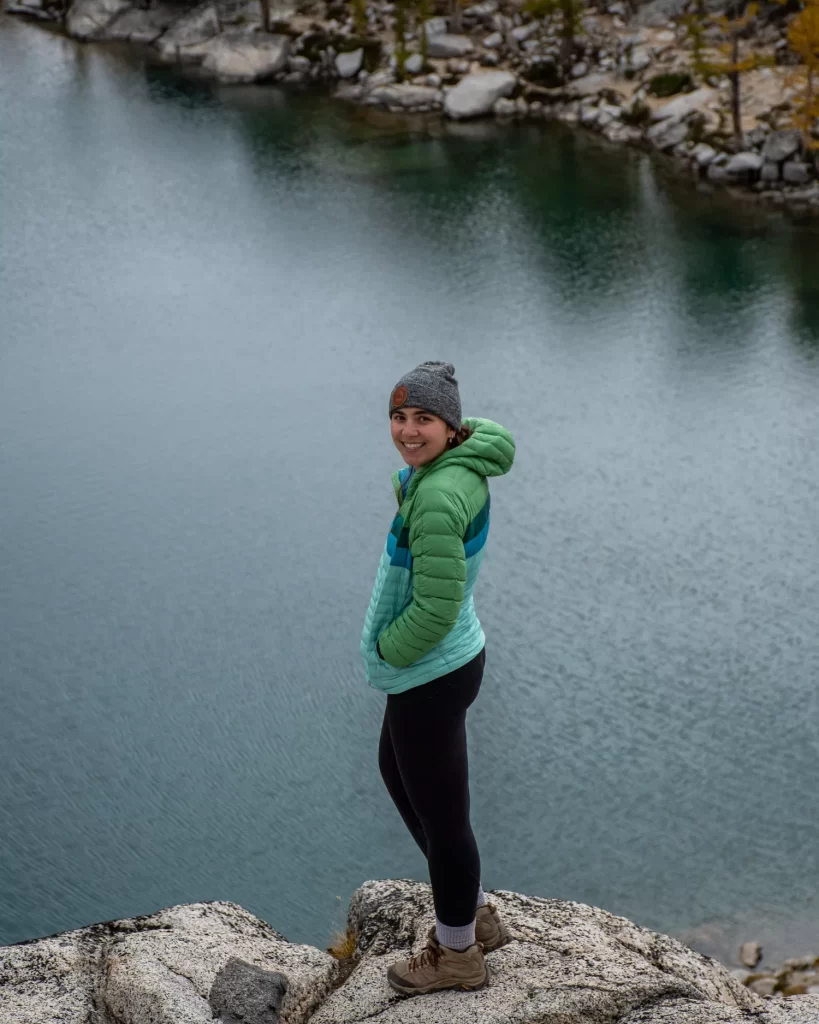 Girl standing above the Inspiration lake with beanie and coat on