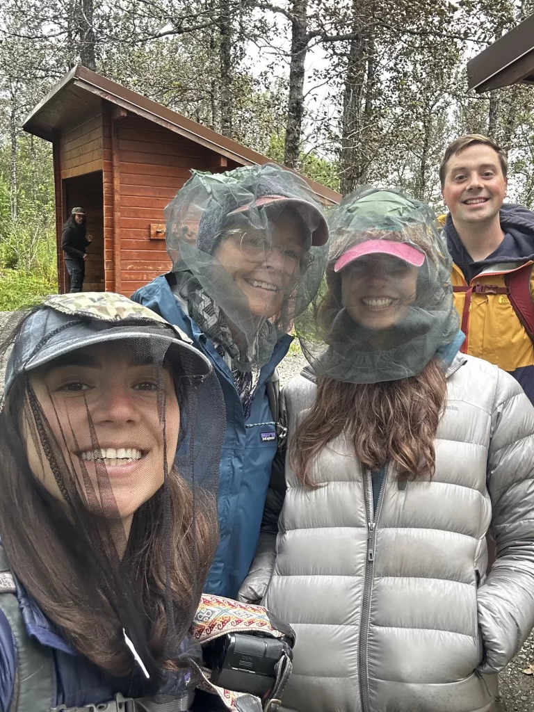 Bug nets on three people with one person without