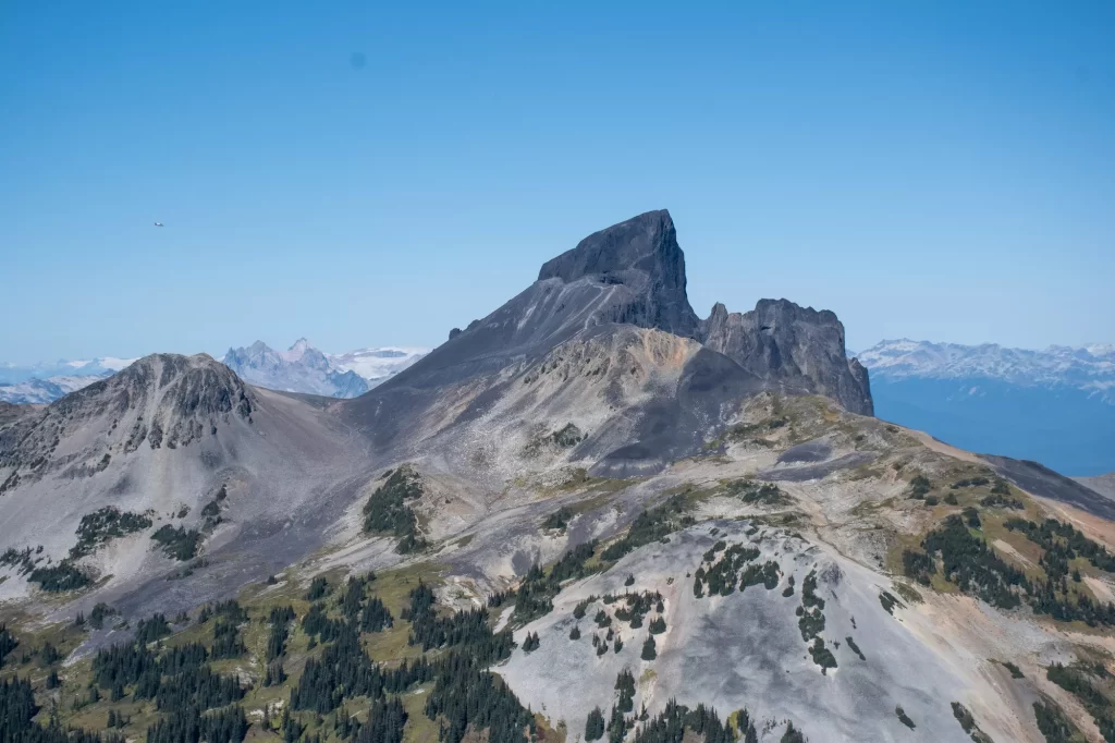 mountain peaks on with mountains rolling in distance