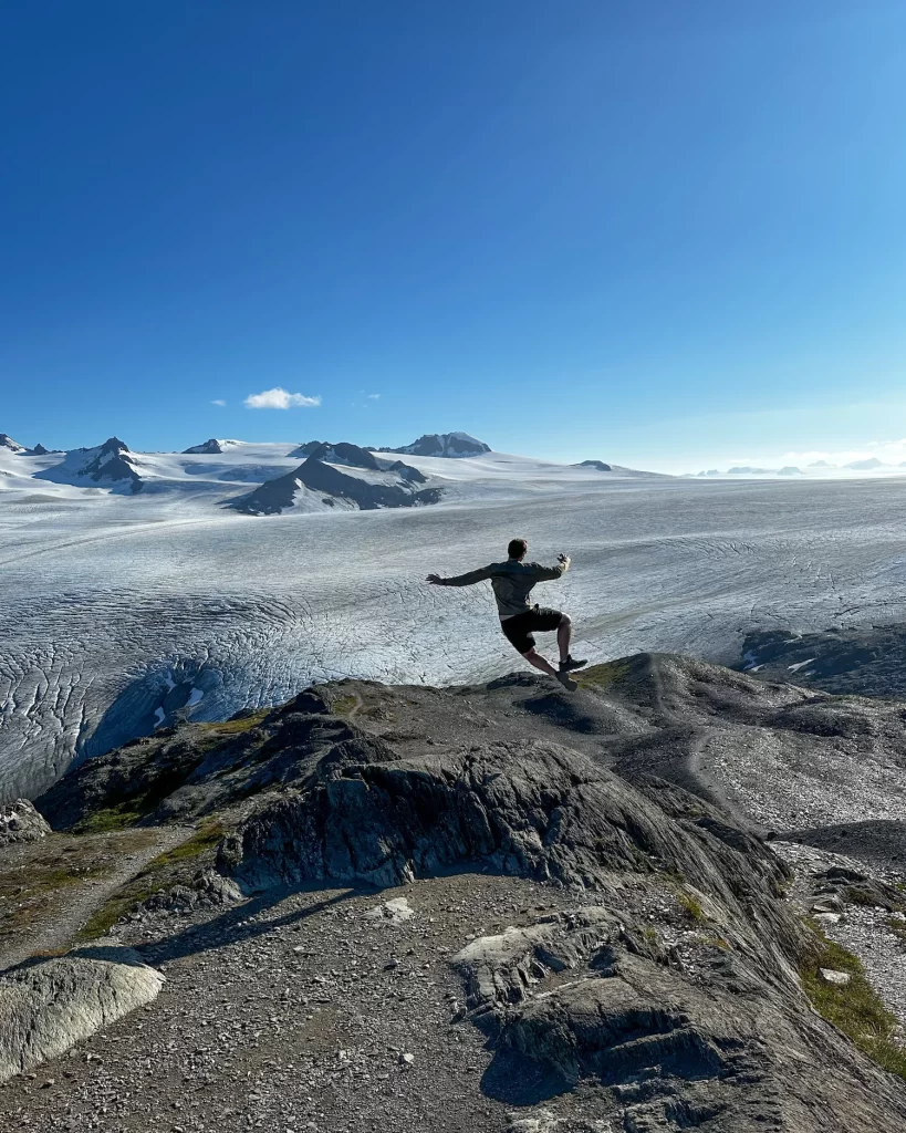 man jumping for joy at the top