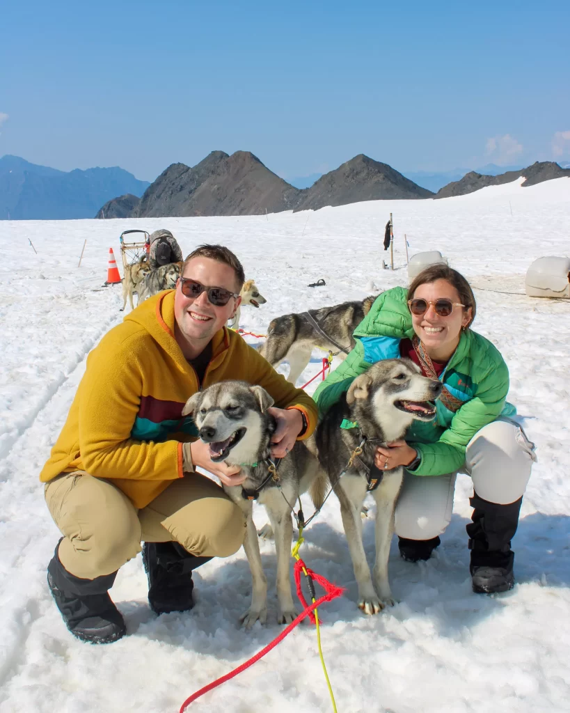 two people with two sled dogs
