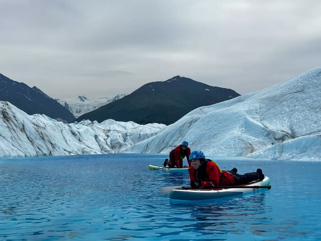 two people floating on paddle boards