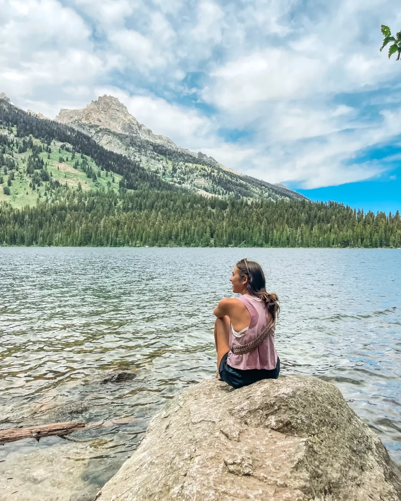girl sitting on a rock at bradley lake