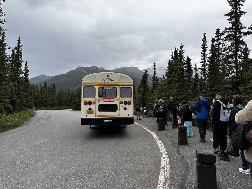 school bus in Denali with people lined up to get on