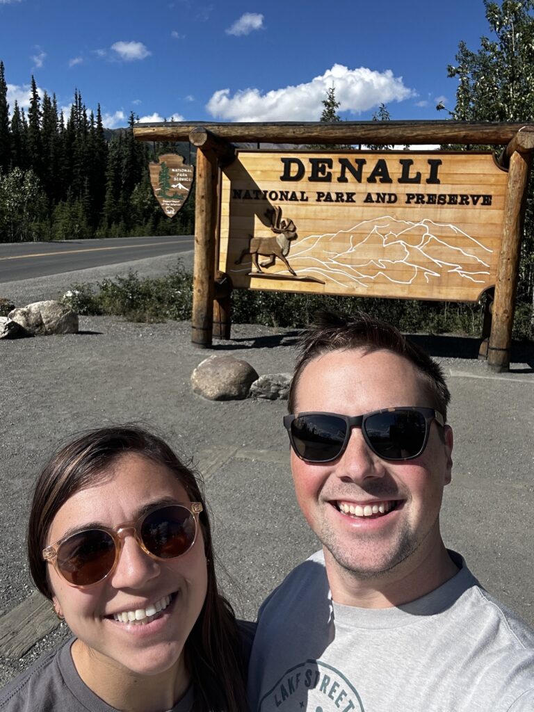 two people in front of park sign