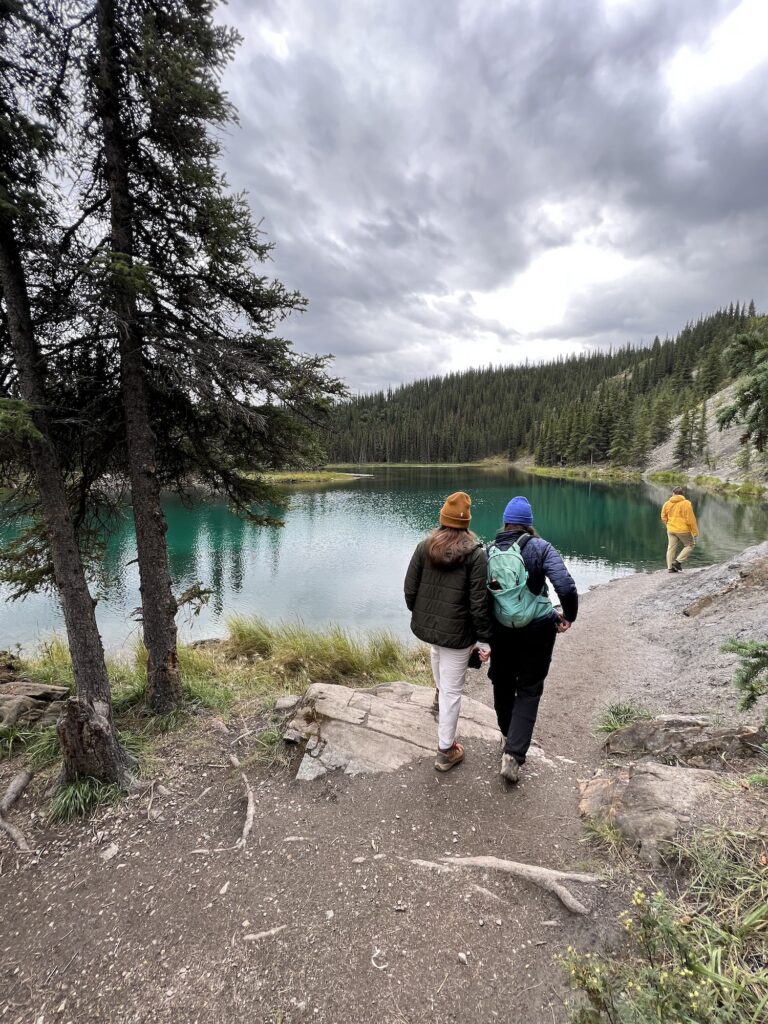 two girls walking around a lake