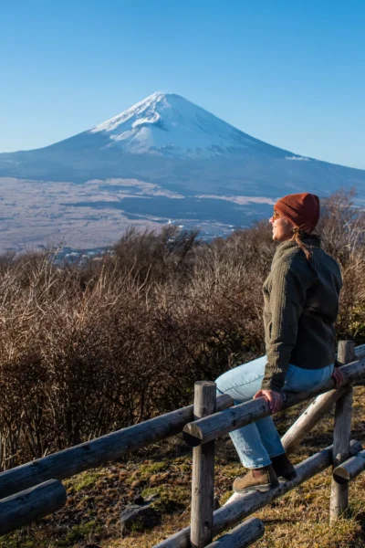 girl sitting in front of mount fuji looking out in hakone