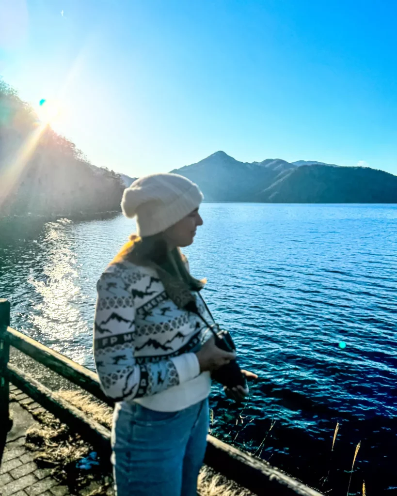 girl standing by the water of lake chuzenji