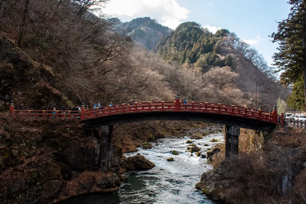 Shinkyo Bridge, a red bridge sitting over a river