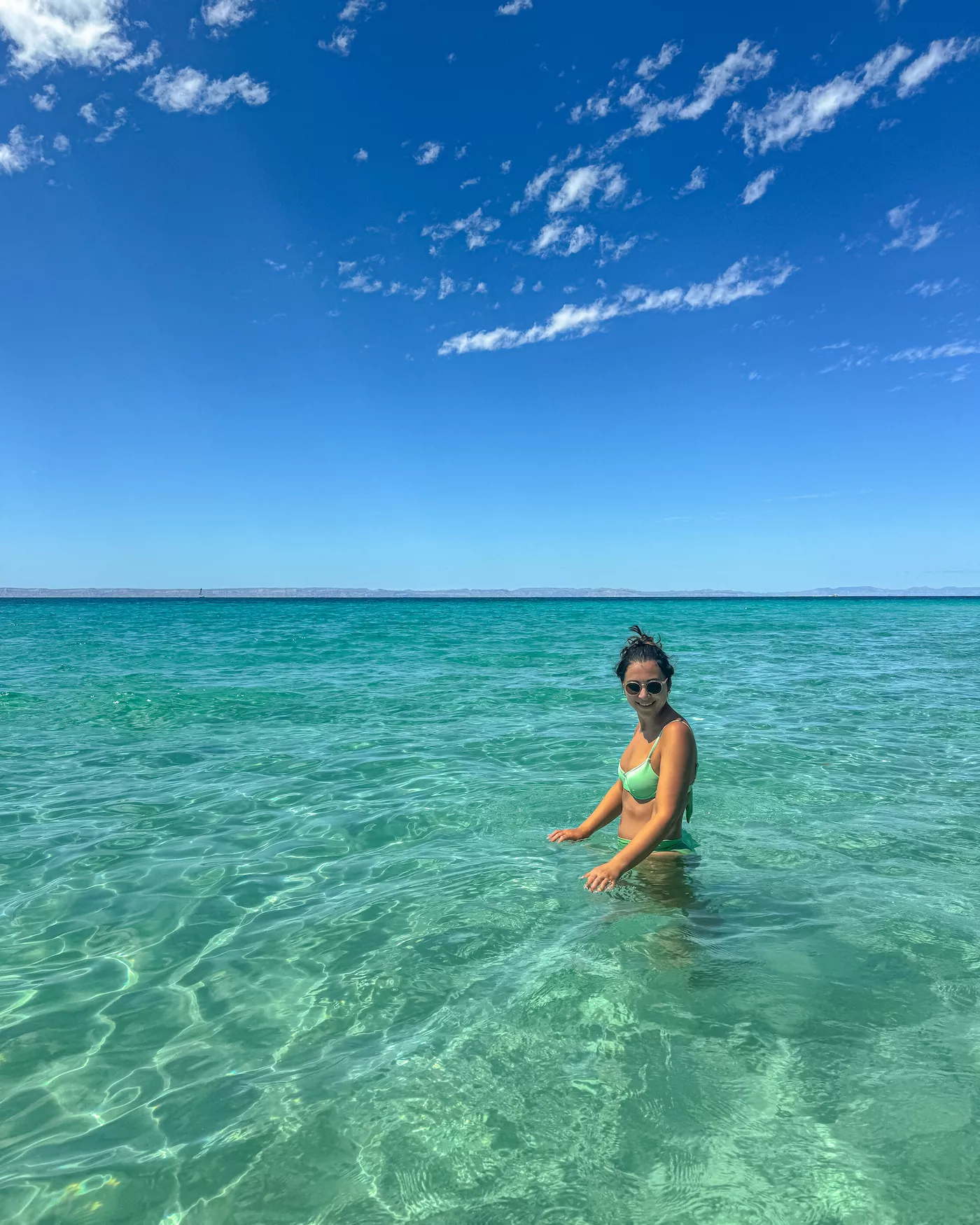 girl in bright blue water at Balandra Beach