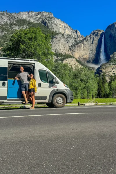 couple standing in front of van with falls
