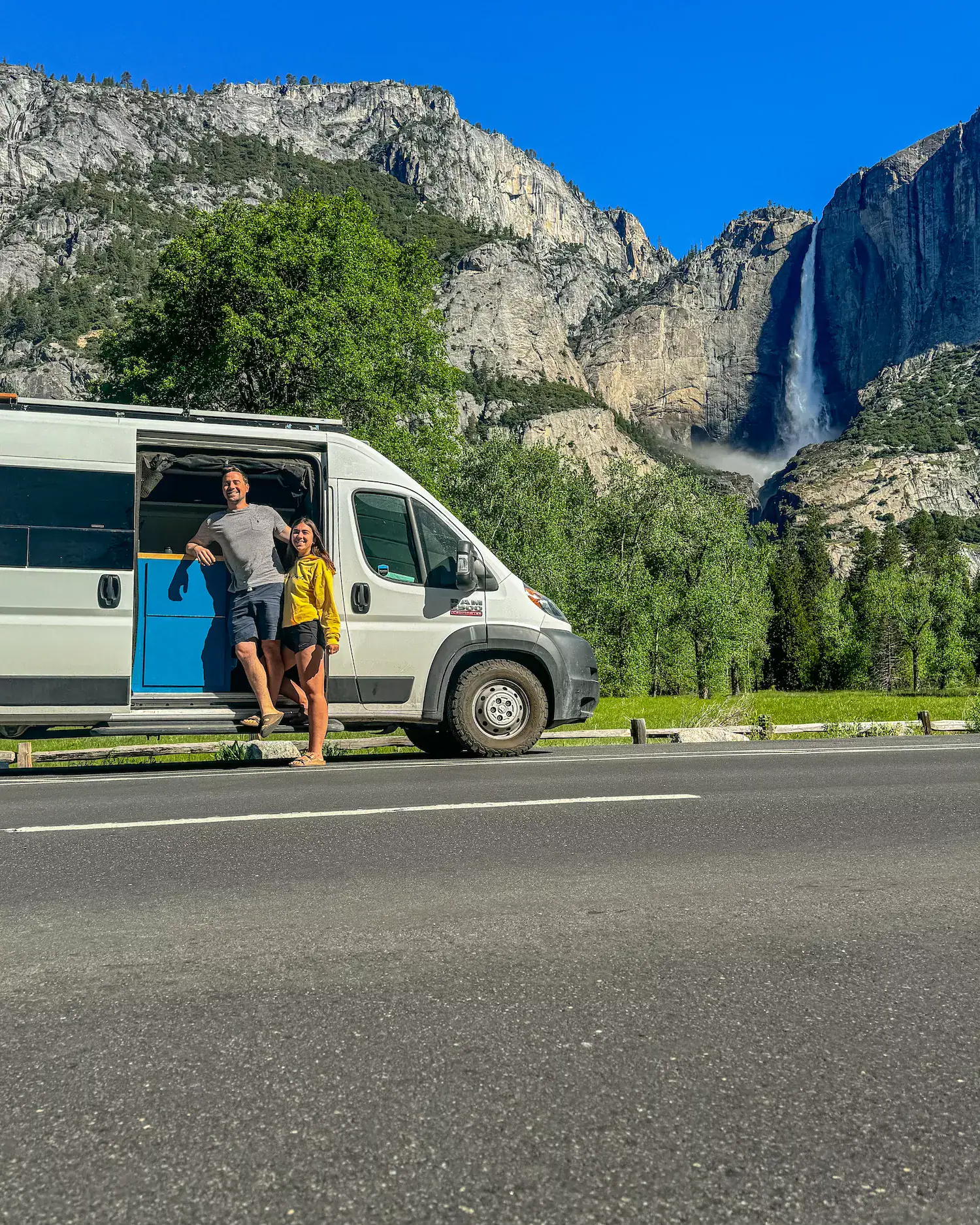 couple standing in front of van with falls