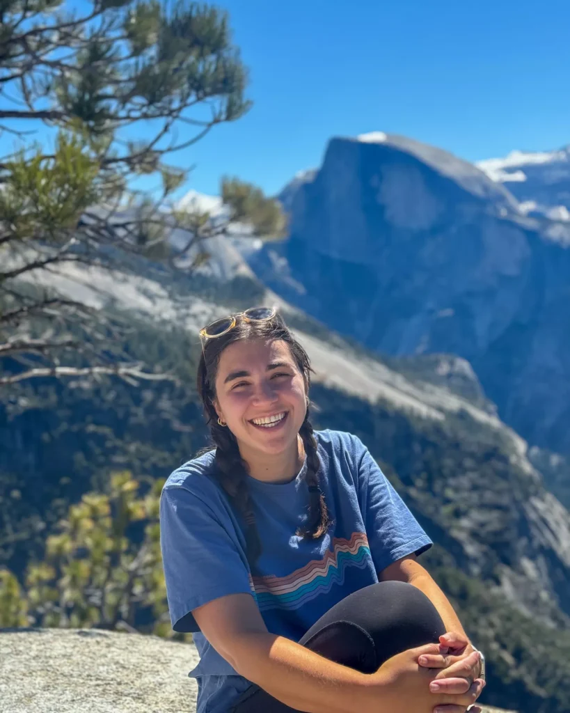 girl smiling in front of Half dome