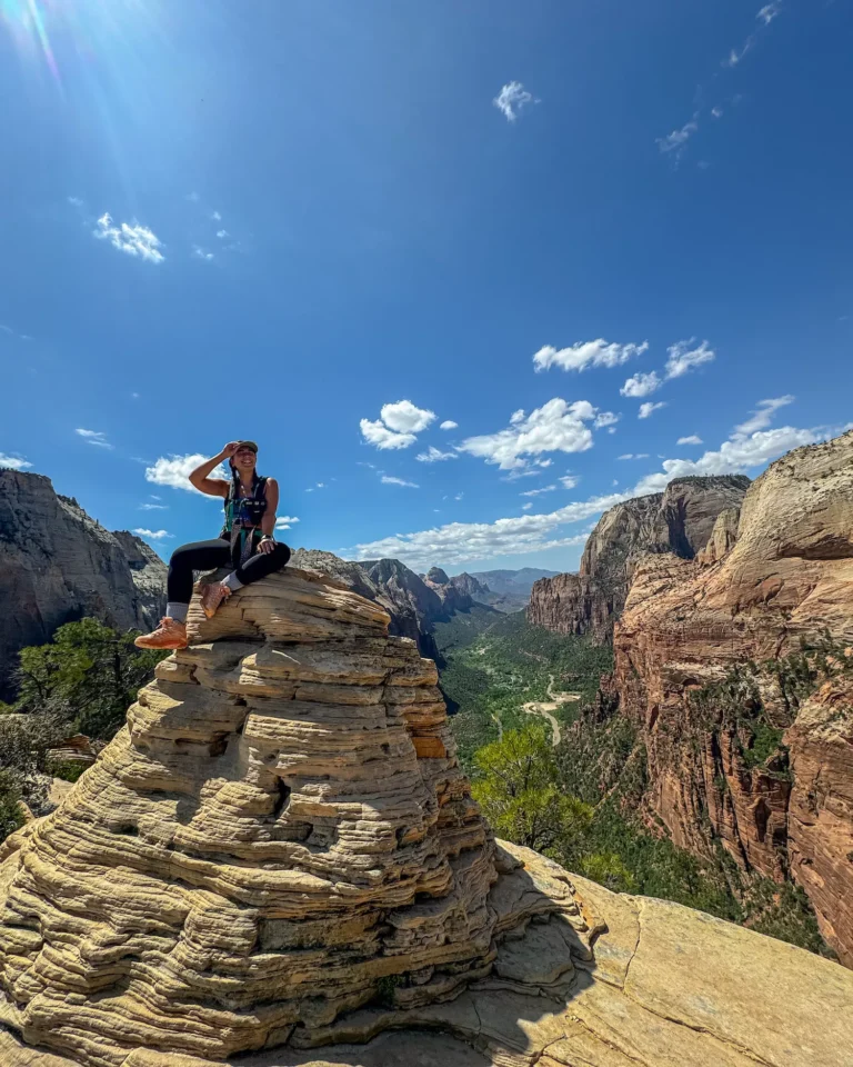 girl sitting on top of rock pile on angels landing in zion