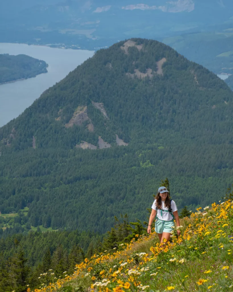 girl smiling while looking at wildflowers