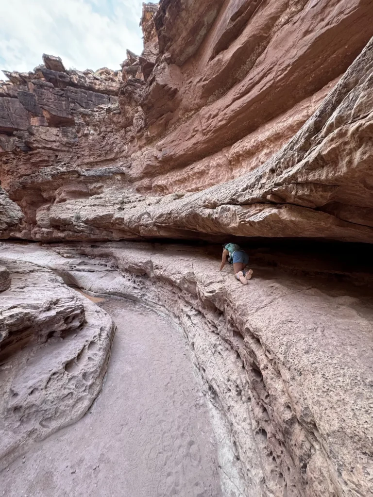 girl crawling under a ledge