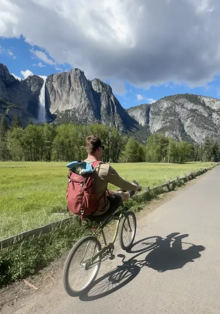 dylan biking in front of yosemite falls