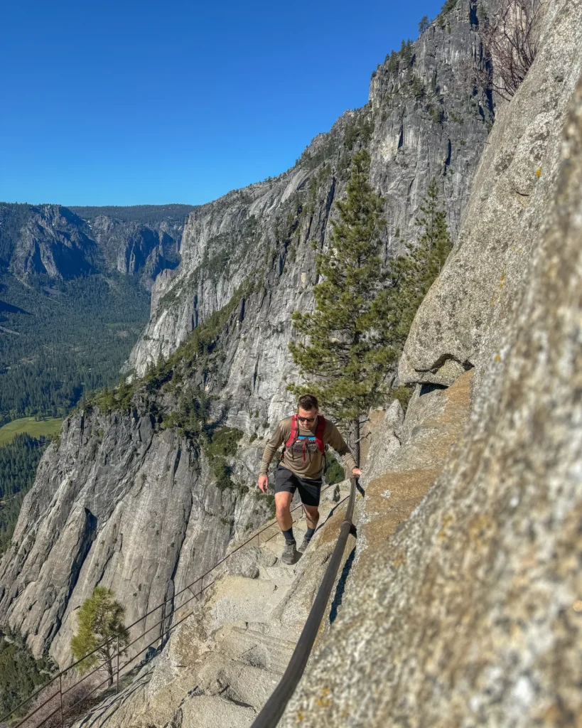 guy walking on edge of mountain