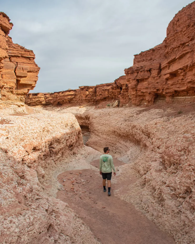 guy walking in the wash where slots begin