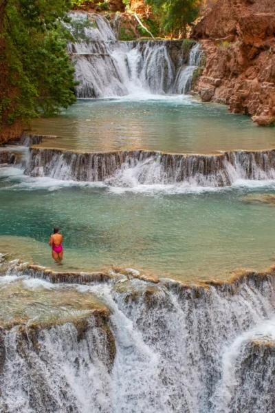 girl sitting at Beaver Falls with cascades around