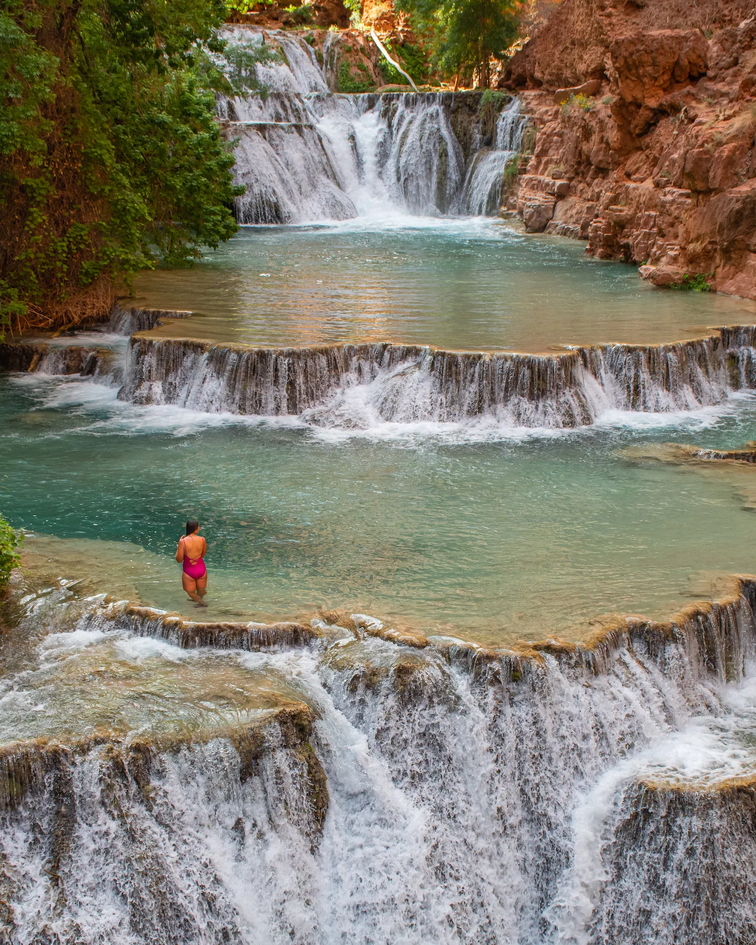 girl sitting at Beaver Falls with cascades around