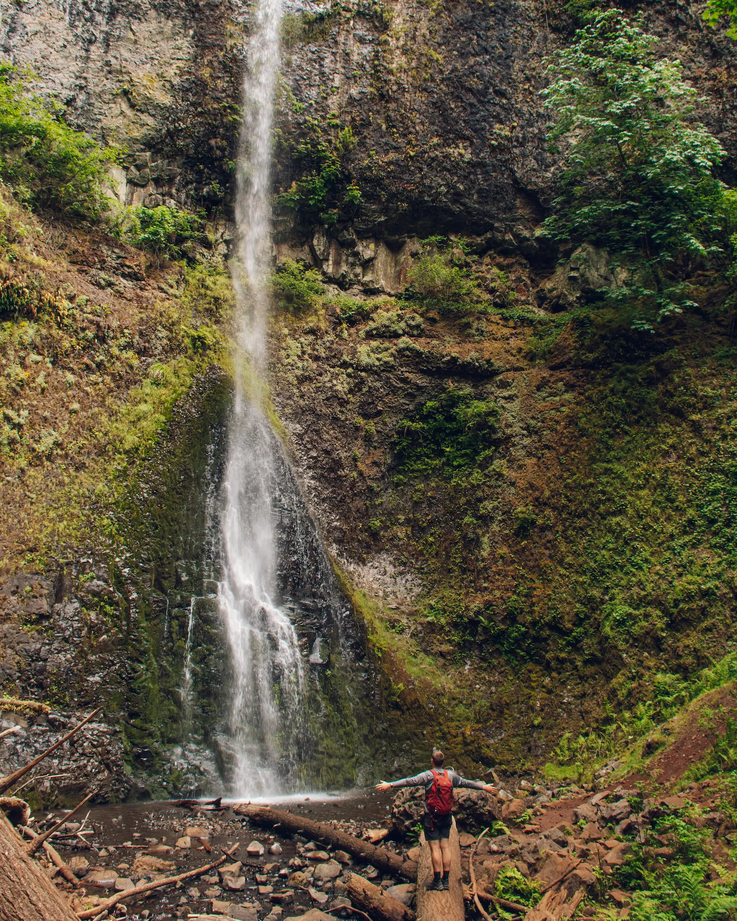 Guy standing under Double Falls on the Trail of 10 Falls