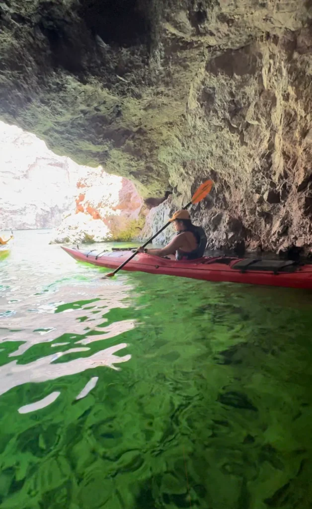 girl kayaking through green water
