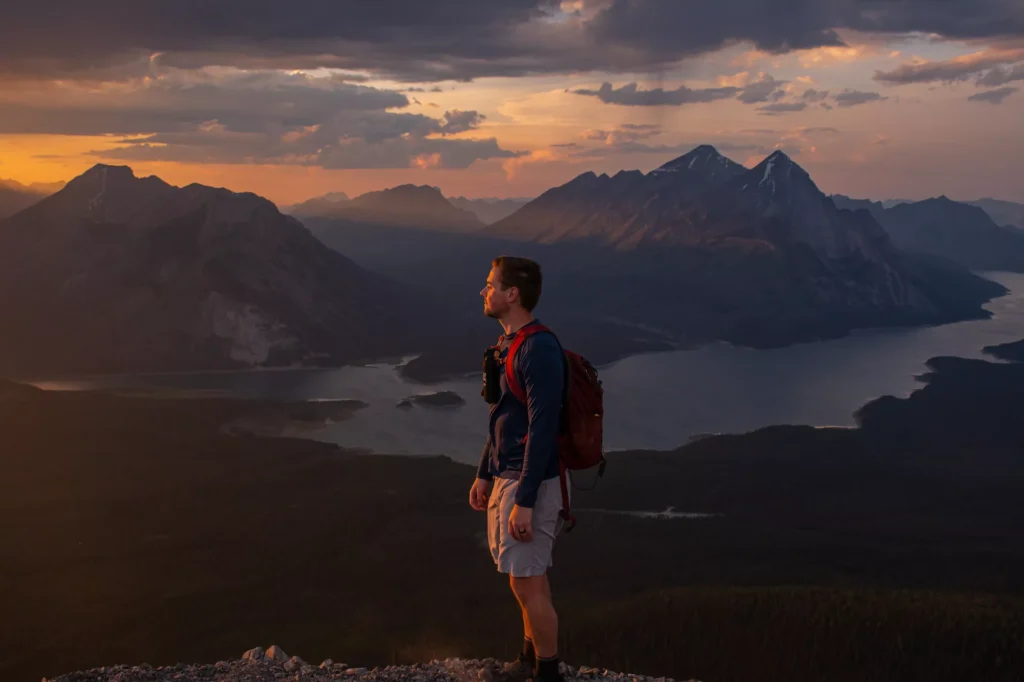 guy standing in front of sunset on tent ridge