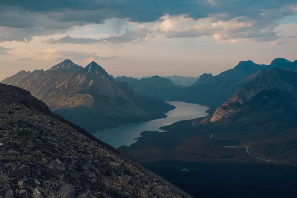 sun hitting the top of the mountains as it sets on tent ridge horseshoe with spray lakes