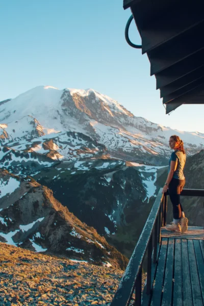 girl looking out from mt fremont lookout/firetower with mt rainier in the back
