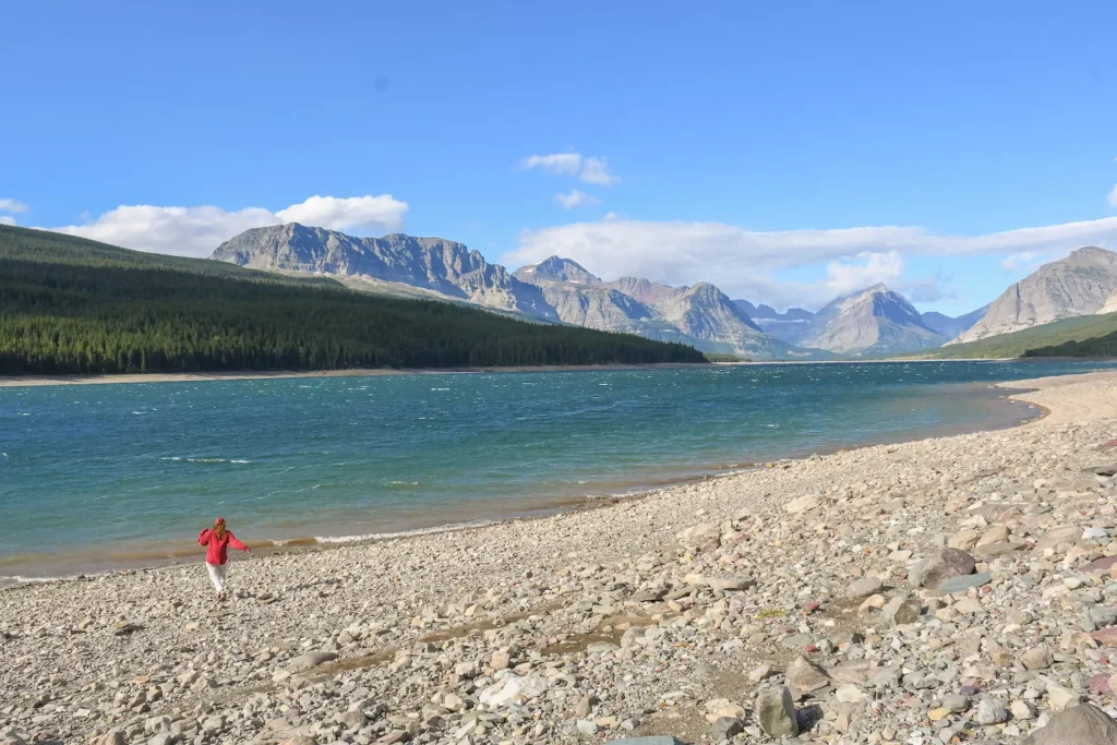 girl standing next to Sherburne Lake